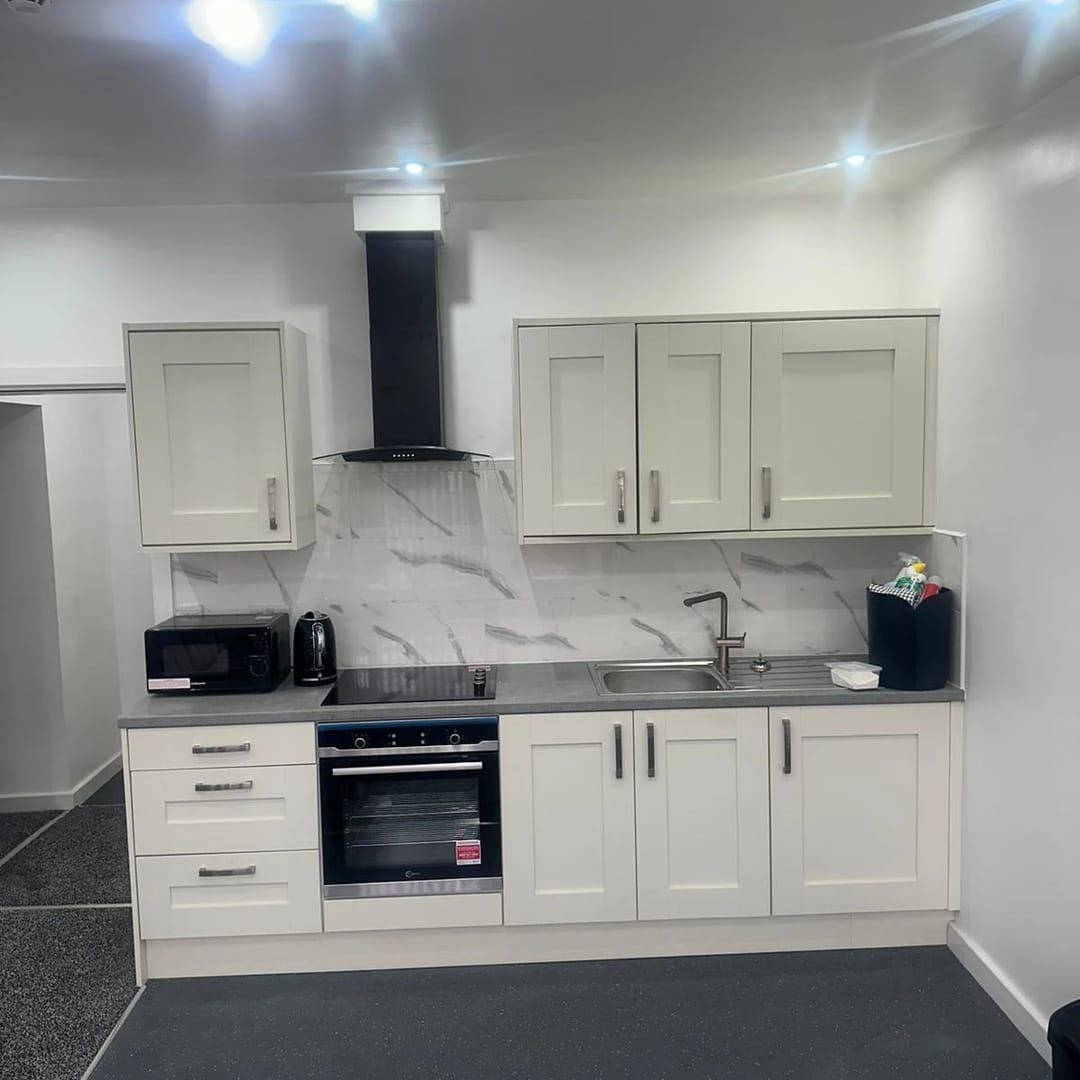 A fitted kitchen in one of our apartments, with an oven, hob and fridge freezer